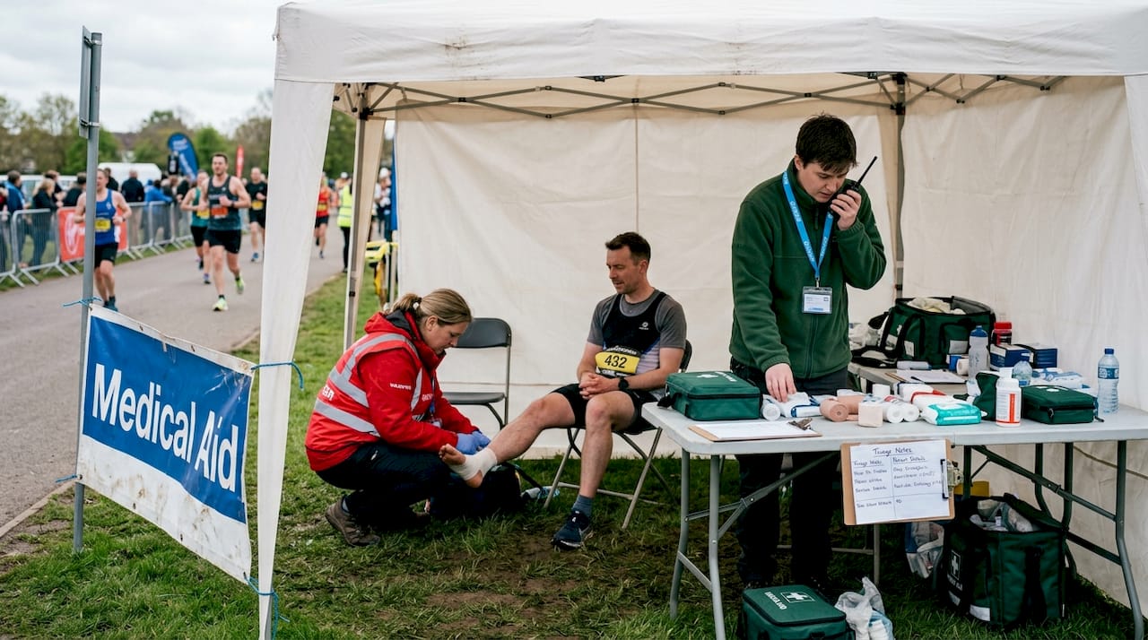 First aid team assists runner during marathon