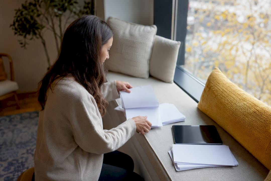 Therapist hands organizing insurance paperwork
