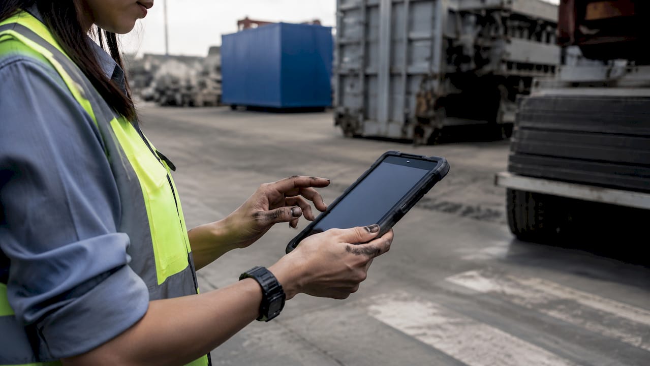 Technician with tablet in mechanical equipment room