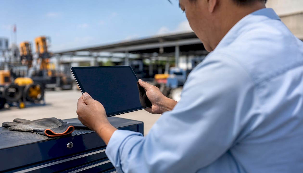 Hands holding tablet in maintenance room