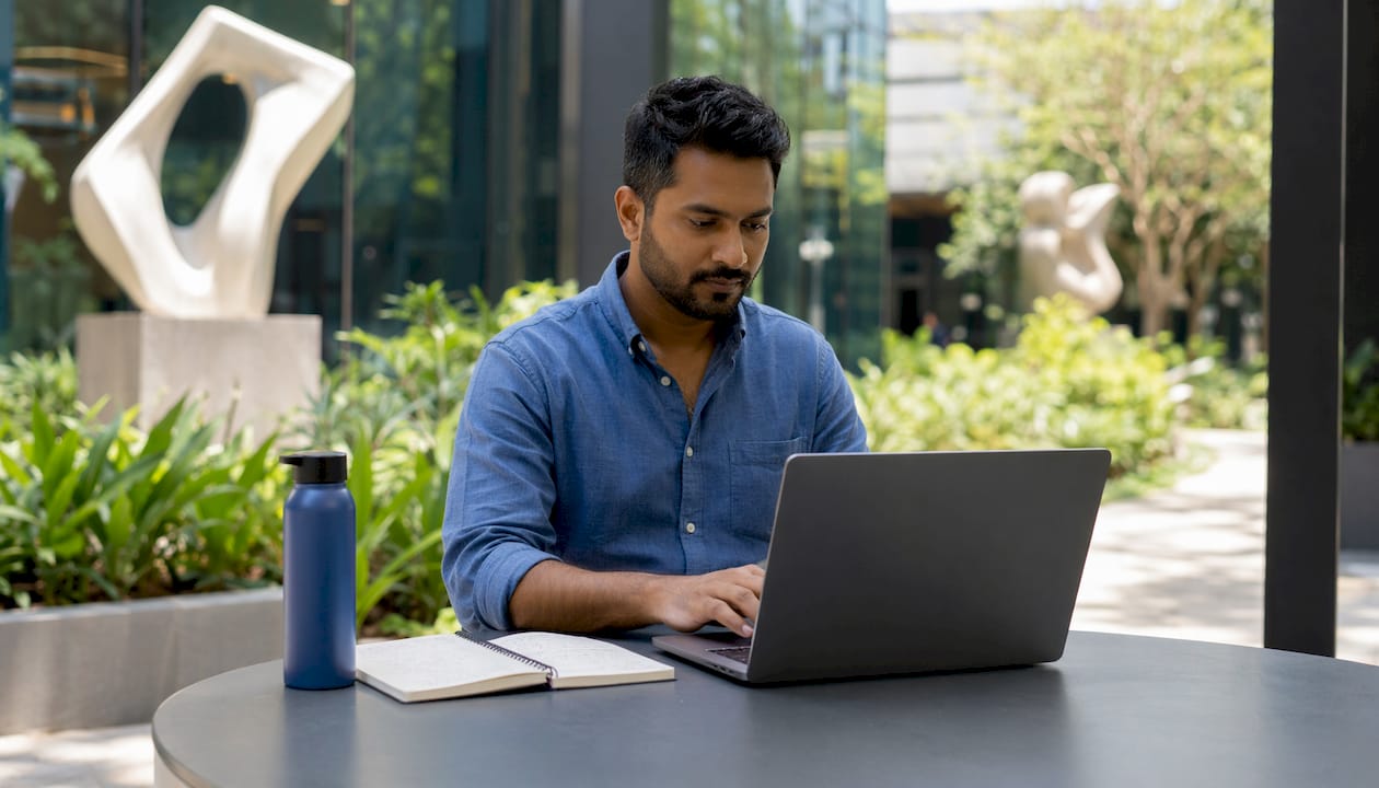 Data analyst working at standing desk in office