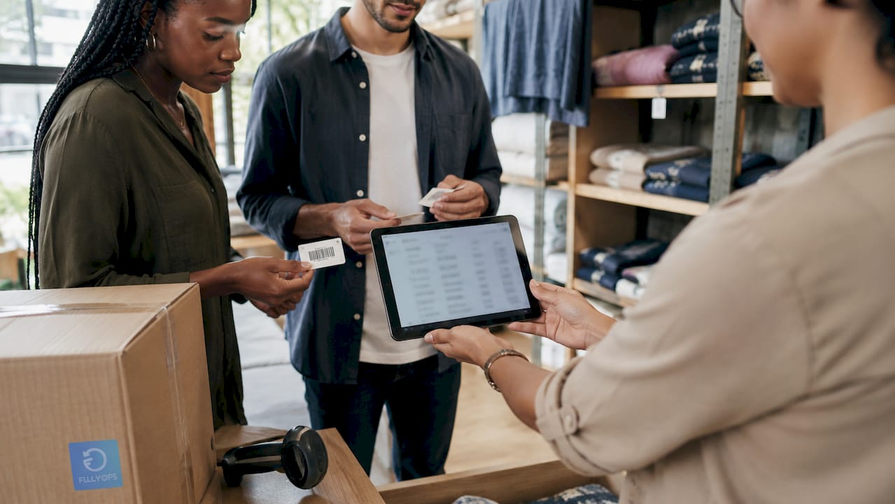Hands checking inventory data on tablet in storeroom