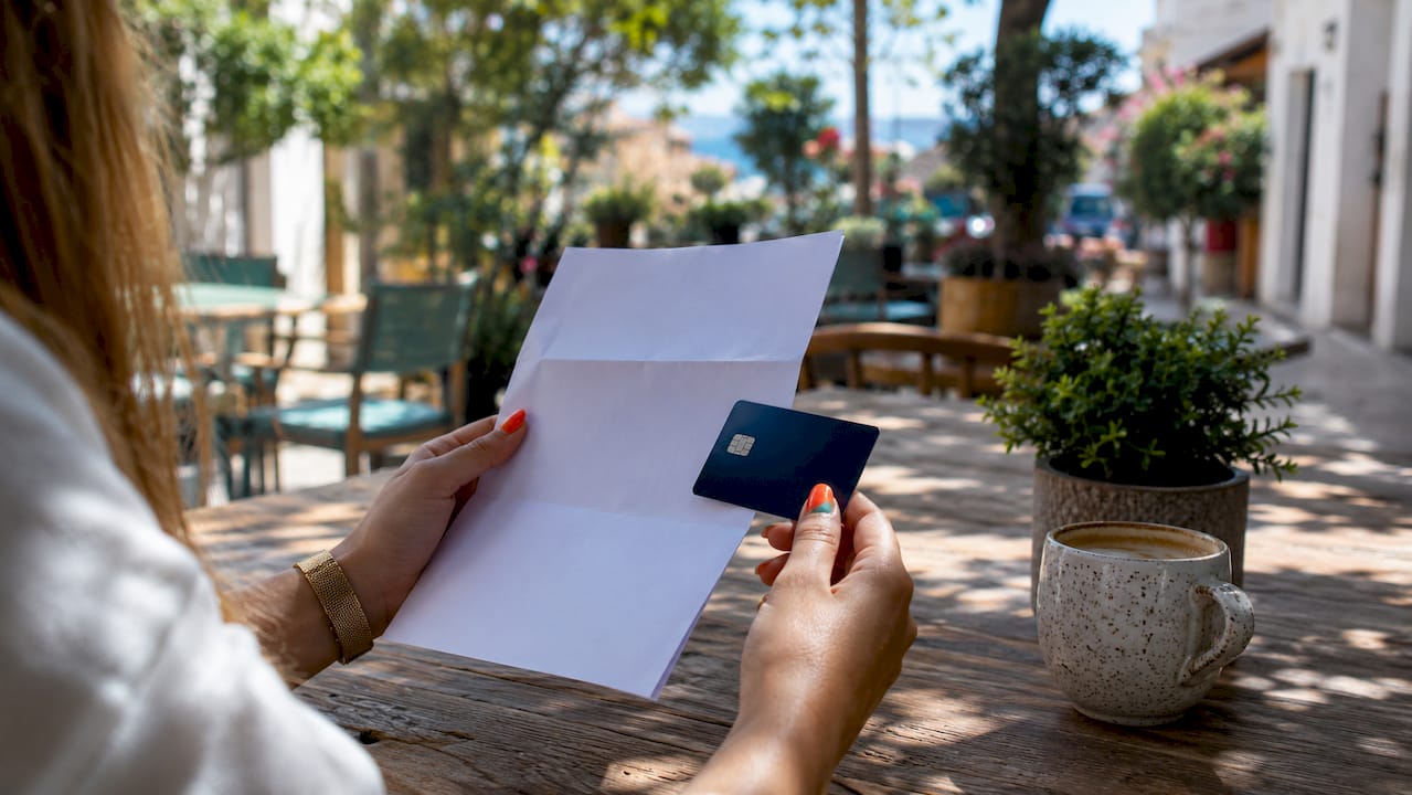 Hands exchanging bank card and documents