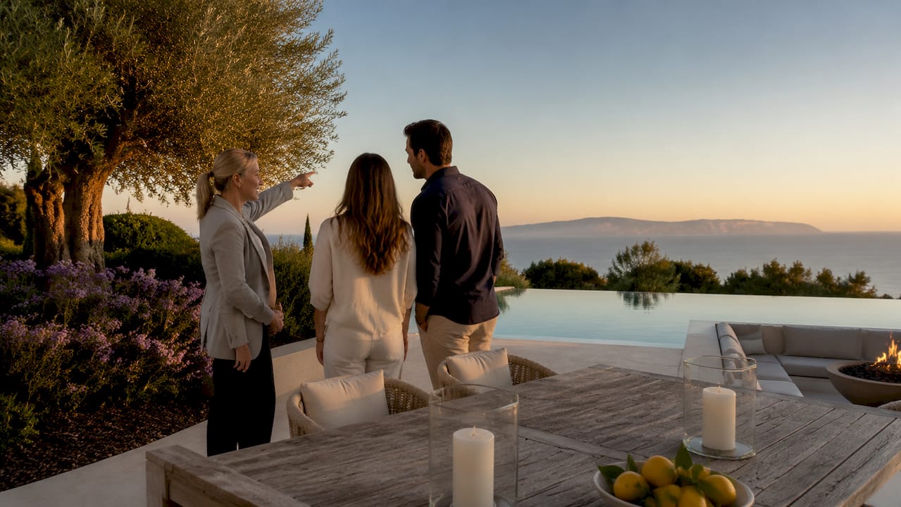 Agent presenting villa pool to buyers