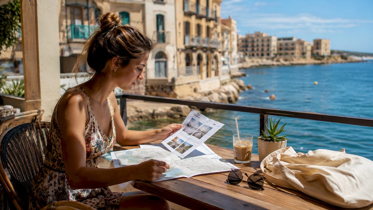 Woman reviewing Palma apartment rental details outdoors