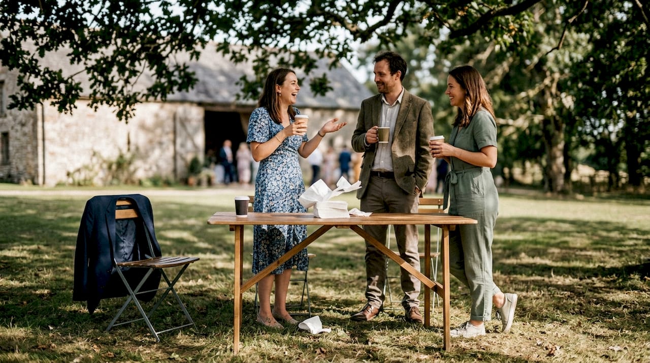 Wedding guests chatting at outdoor table