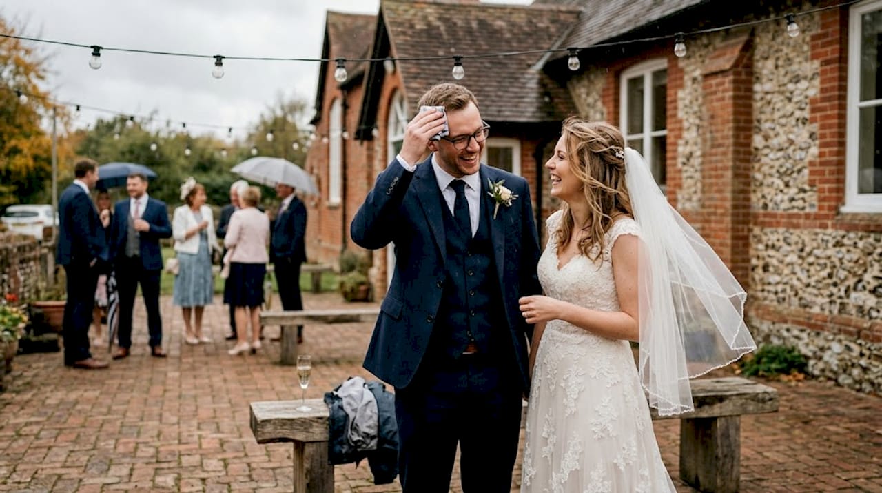 Laughing wedding couple outdoors after ceremony