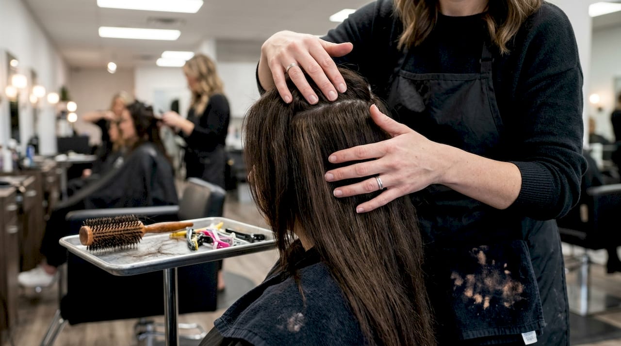 Hands showing seamless hair weft blending