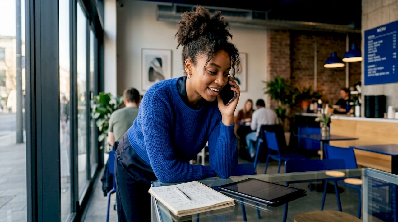 Young woman discussing IT sales on phone