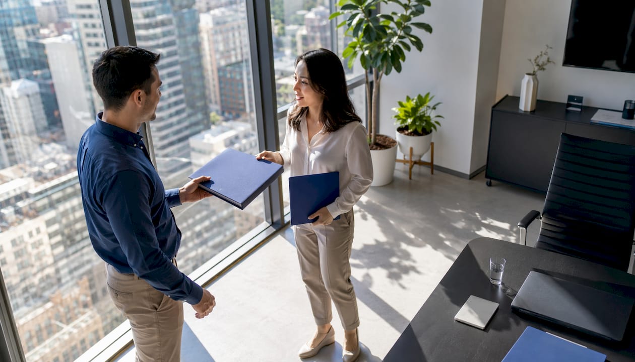 Hands exchanging buyer and sales enablement materials