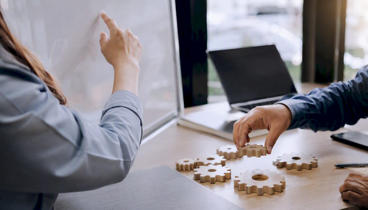 Hands adjusting puzzle pieces representing CRM mapping