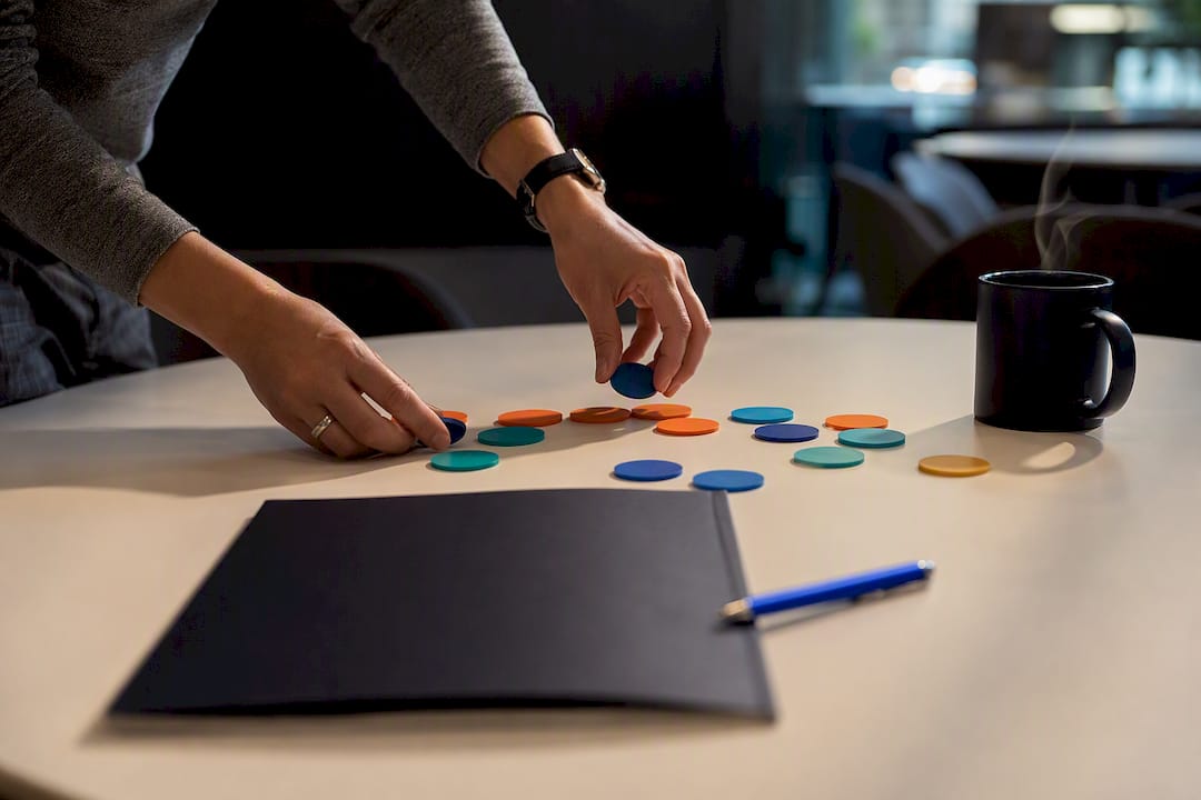 Hands placing tokens on pricing matrix