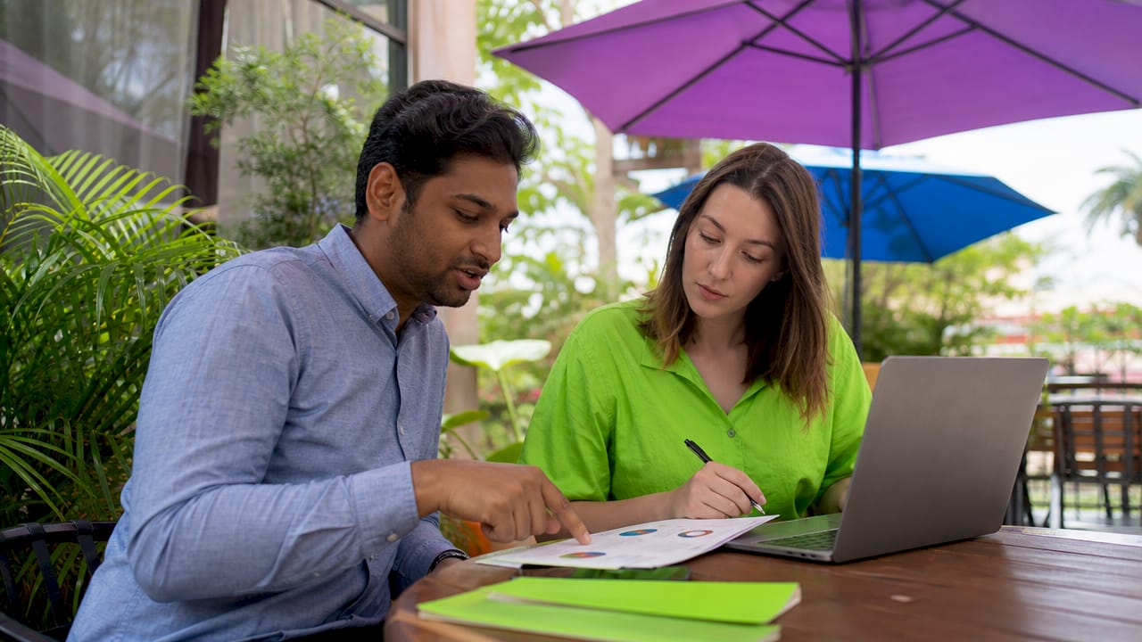 Why Online Surveys Matter for Research and Decisions 2 Two coworkers discussing survey data collaboratively
