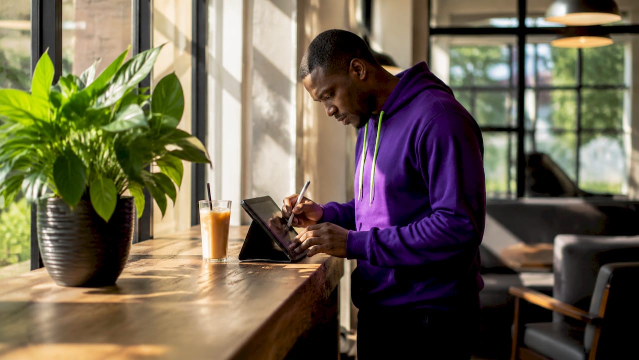 Close-up hands working affiliate links on tablet