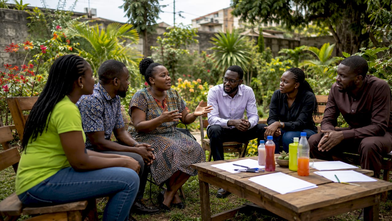 The Role of Citizen Feedback in Nigerian Governance 2 Nigerian community members discussing feedback outdoors