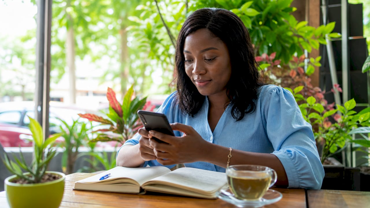 How to Verify NIN in Nigeria: 2026 Step-by-Step Guide 3 Hands operating NIMC Mobile ID app on smartphone