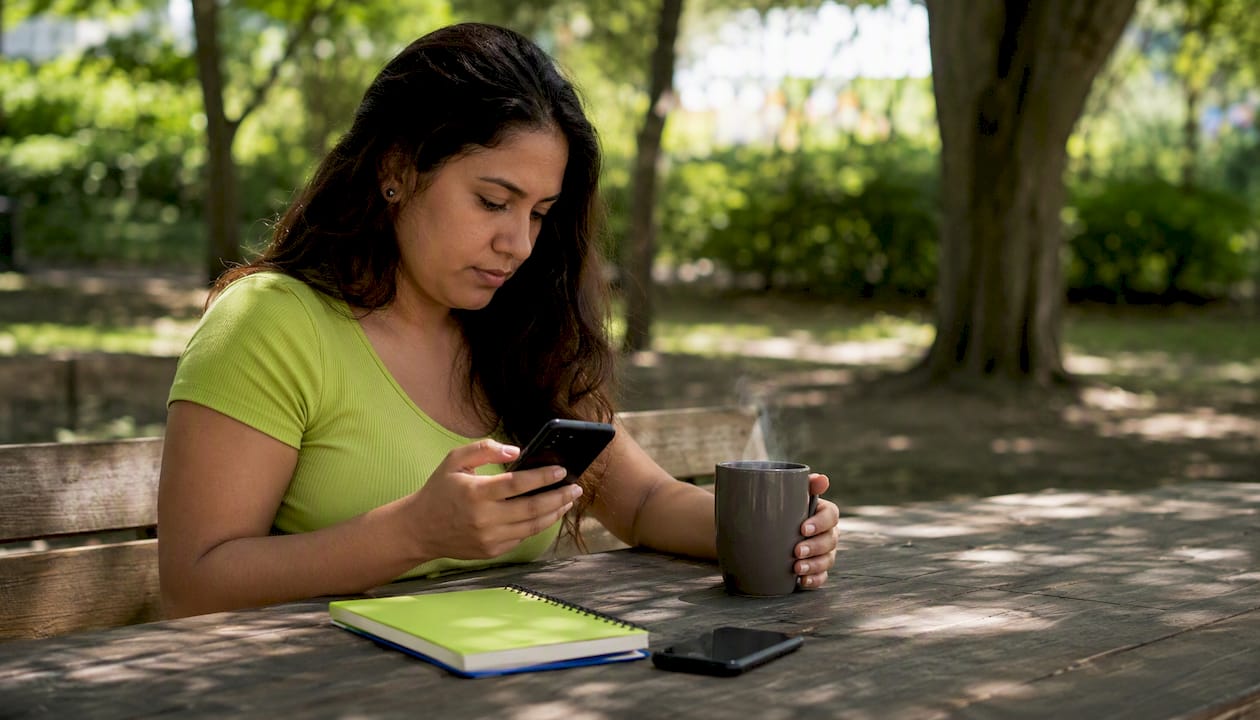 The Best iunlocker.com Alternatives for IMEI Checks 4 Hands entering data on smartphone in café