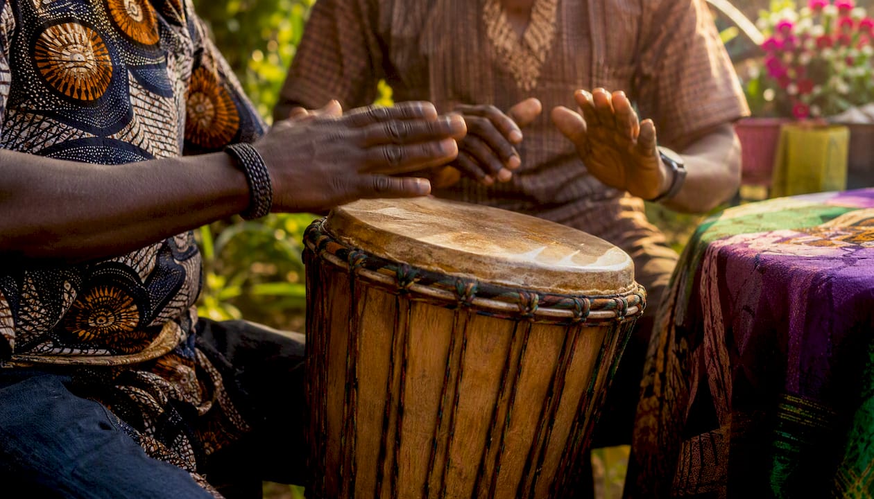 Where to Listen to Nigerian Radio Online and Join the Discussion 2 Hands tapping traditional Nigerian talking drum
