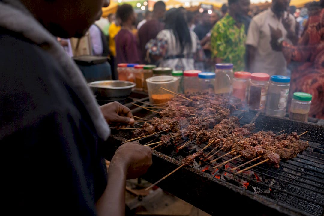 Vendor grilling suya at Nigerian festival