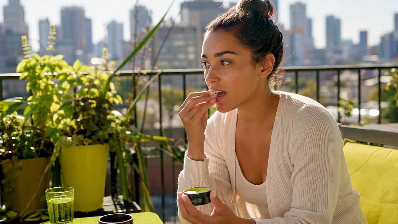 Woman preparing to place nicotine pouch
