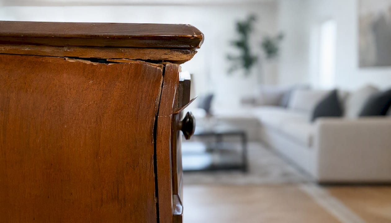 Close-up of winter-damaged wooden dresser drawer