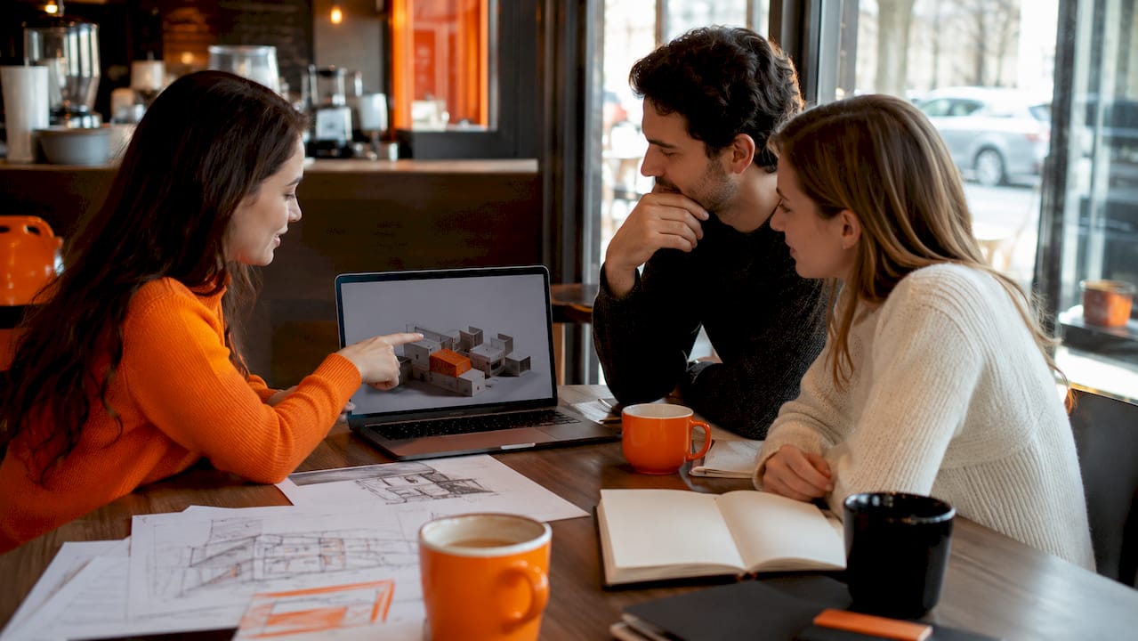 Team discussing 3D product render in office