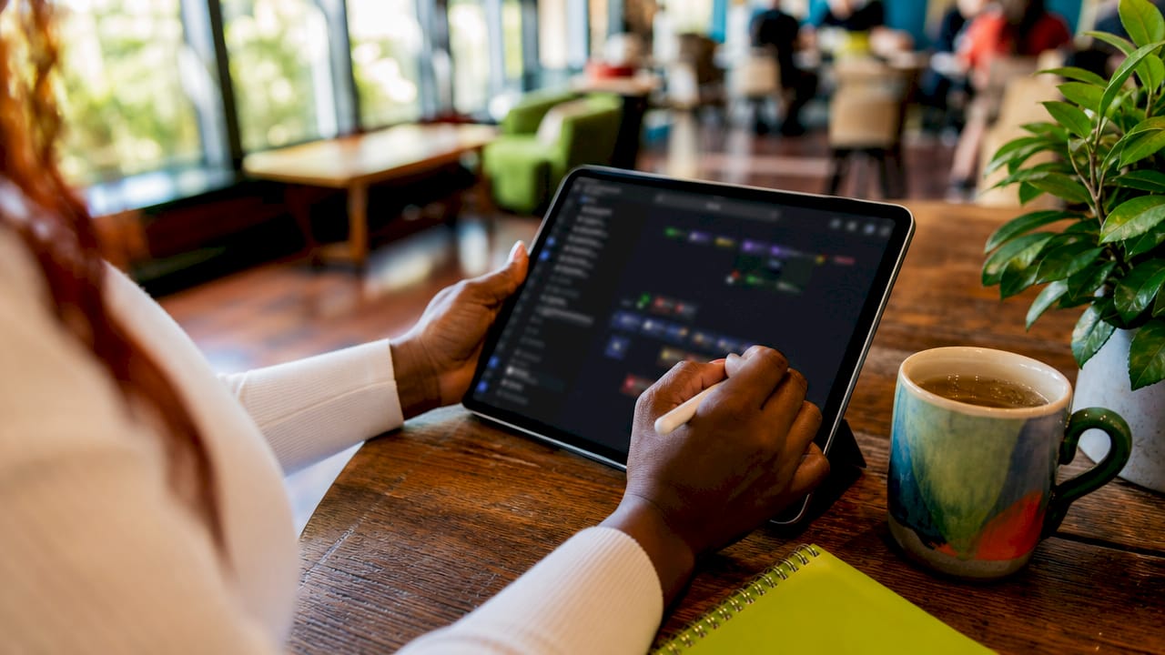 Hands using AI content tool on tablet