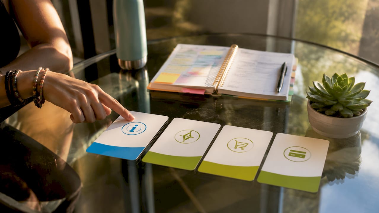 Flat-lay of four search intent type cards with hand pointing