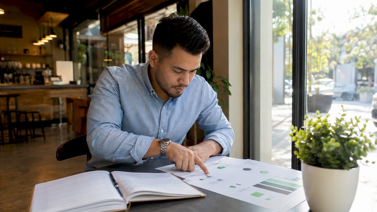 Hands reviewing cannabis brand governance documents
