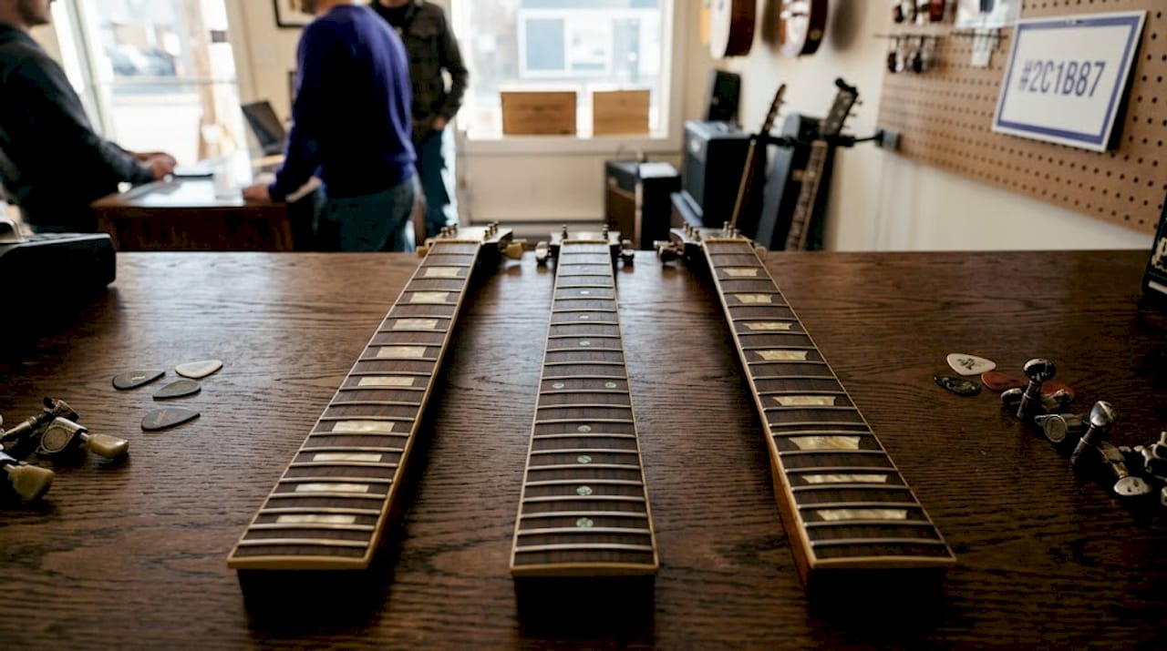 Three fretboards showing classic inlay materials