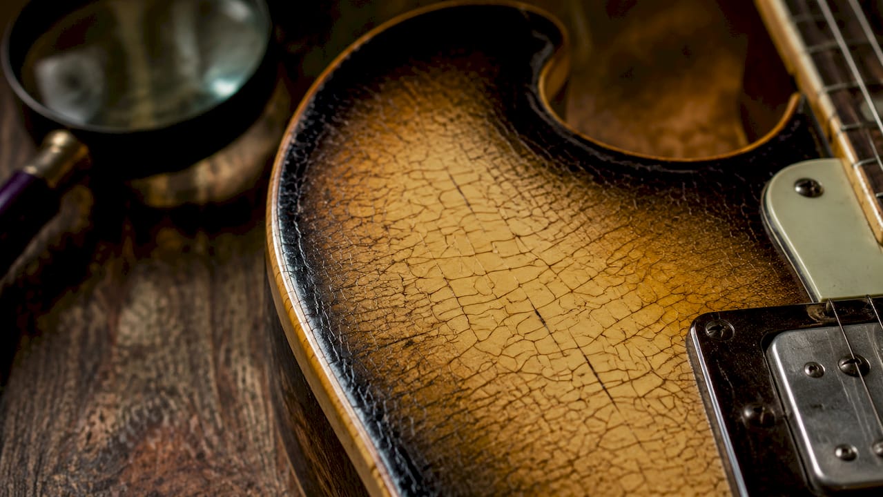 Macro close-up of fine finish checking cracks on guitar