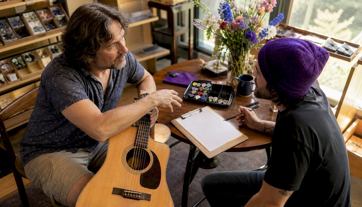 Guitar player and technician discussing setup
