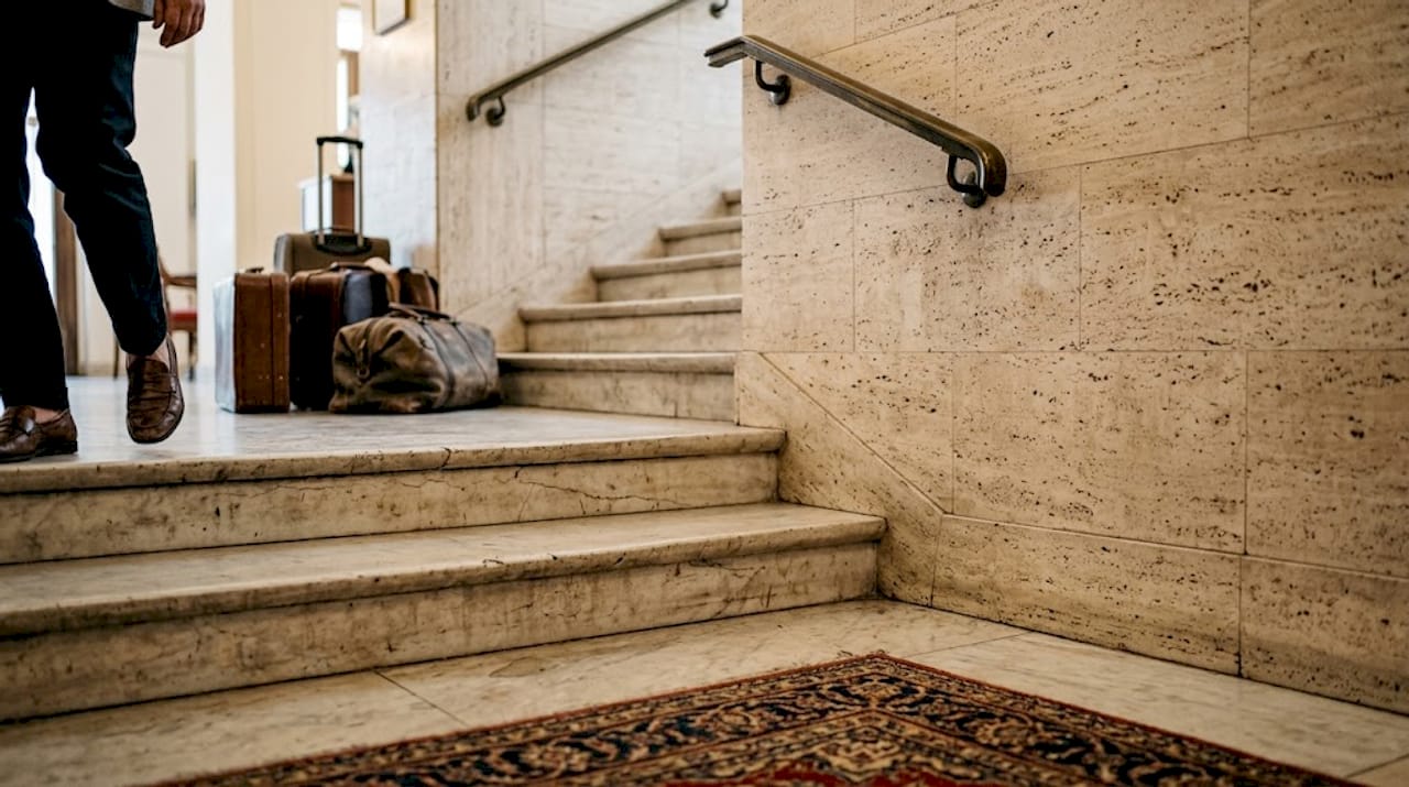 Marble stairs and travertine wall with real wear