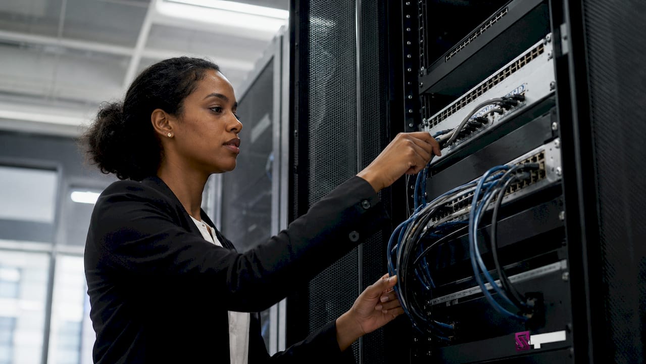 Engineer operating TSN switch in server room