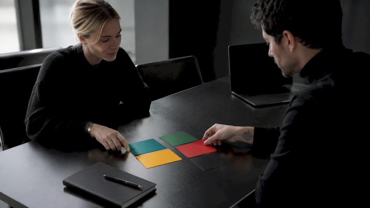Hands arranging colored zone cards on table