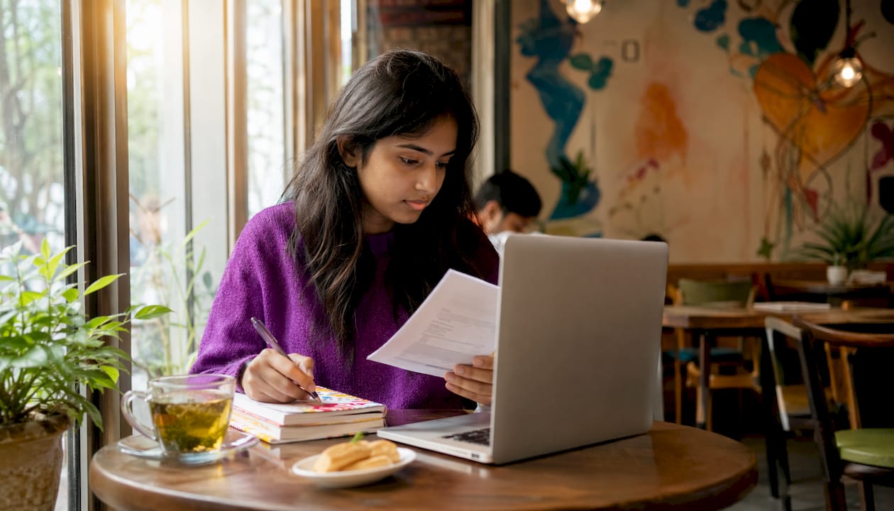 Individual shopper reviewing insurance plans at desk