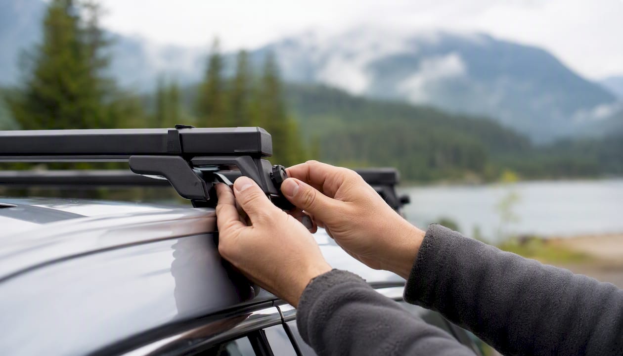 Hands installing car roof rack