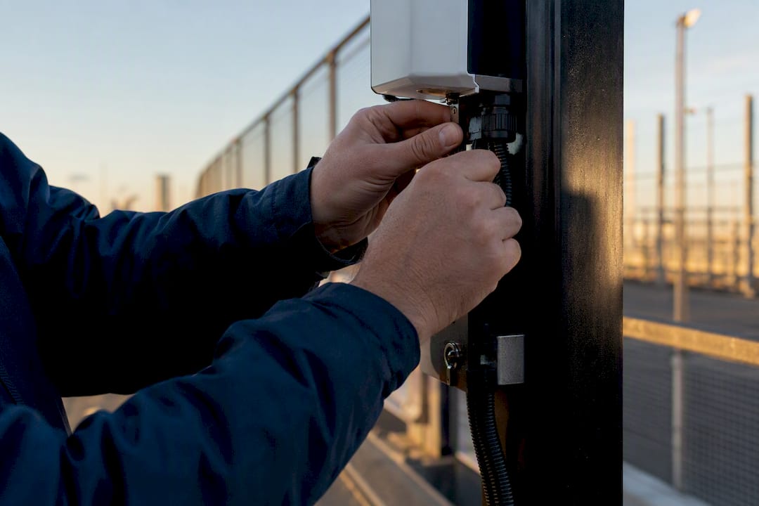 Technician calibrating security sensor hardware