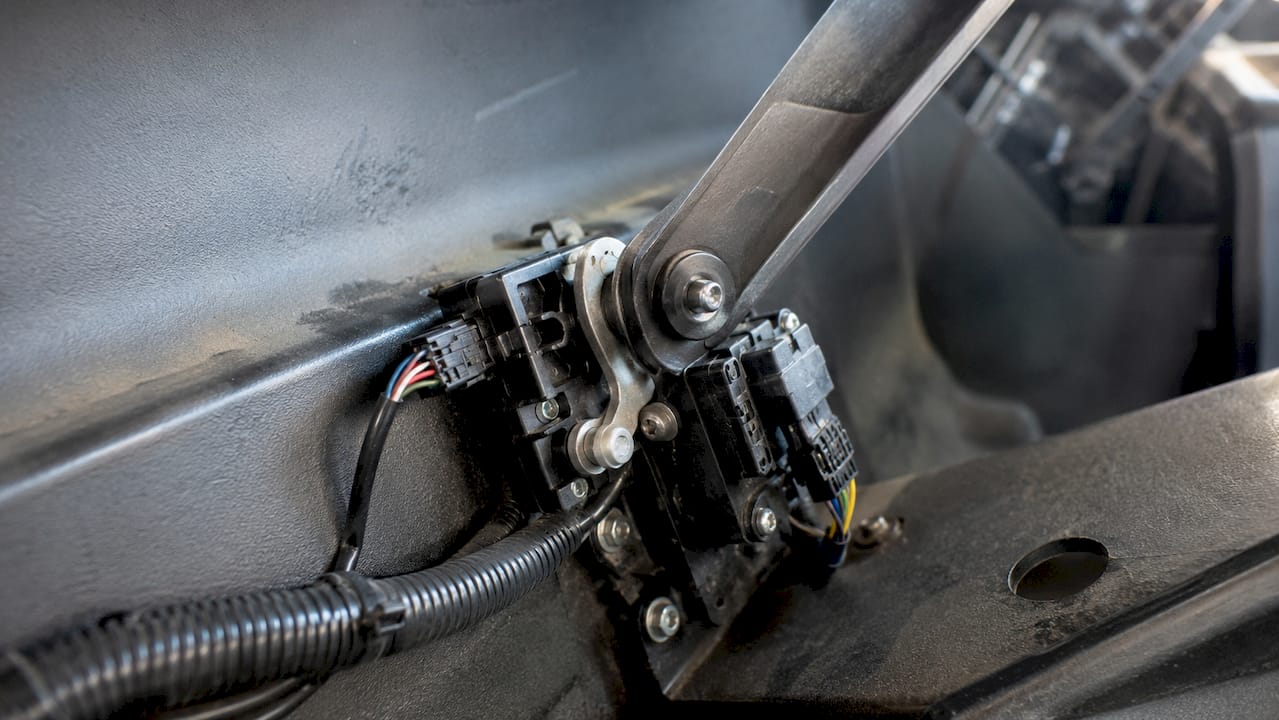 Close-up view of golf cart pedal and sensor