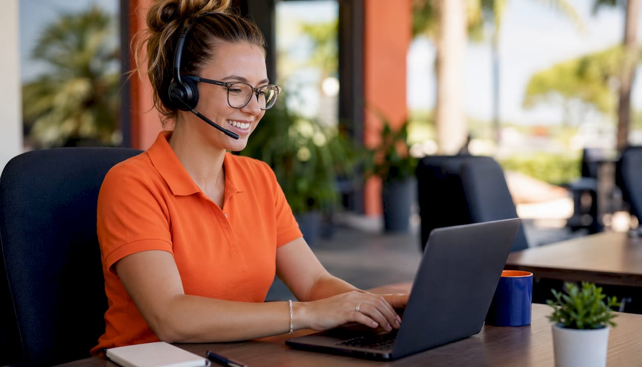 Customer support agent at call center desk