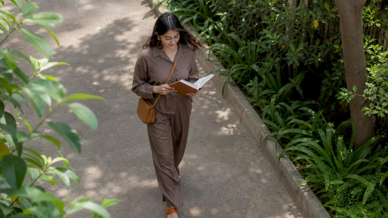 Busy woman in co-ord walking outdoors
