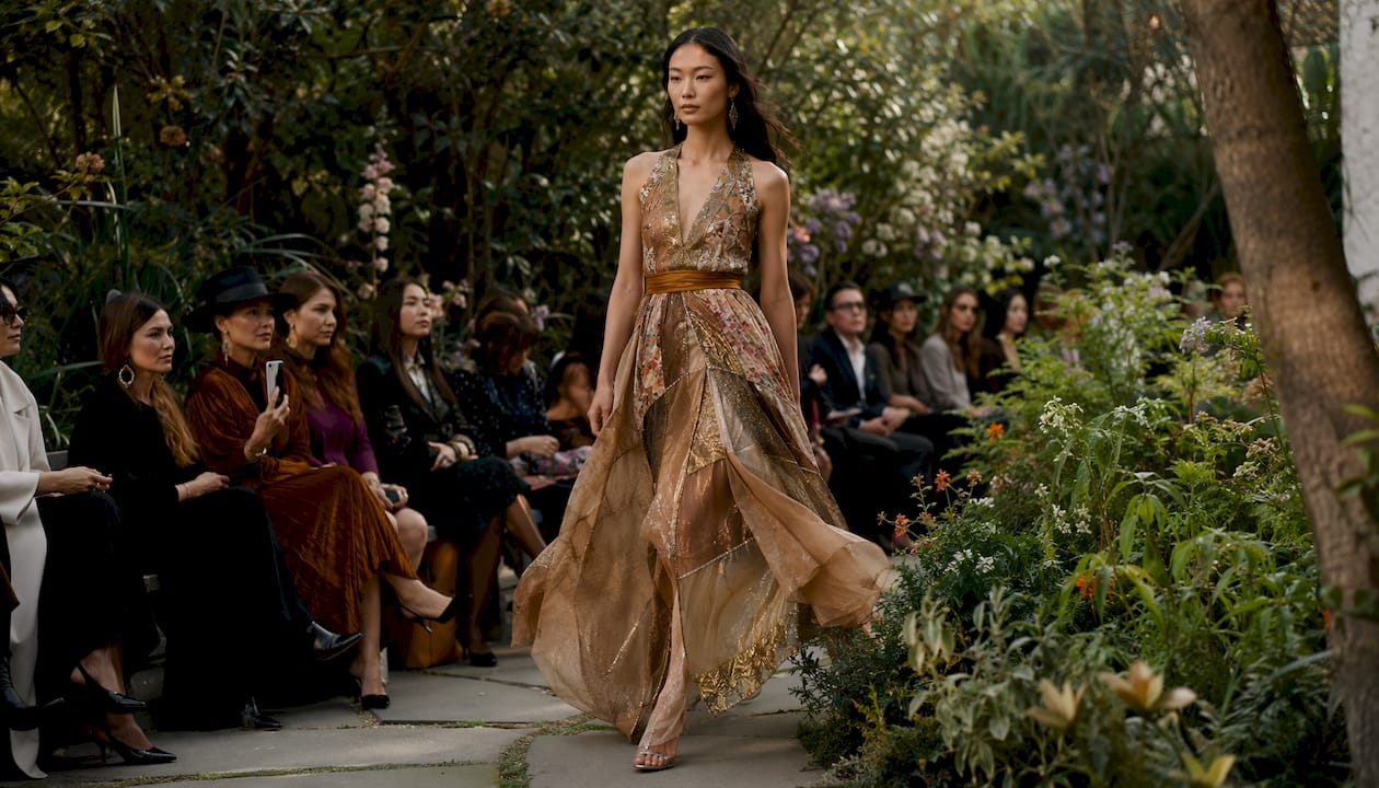 Model showcasing upcycled evening gown on runway