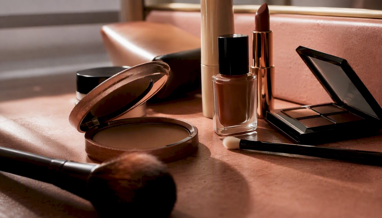 Partial beauty product close-ups on warm surface