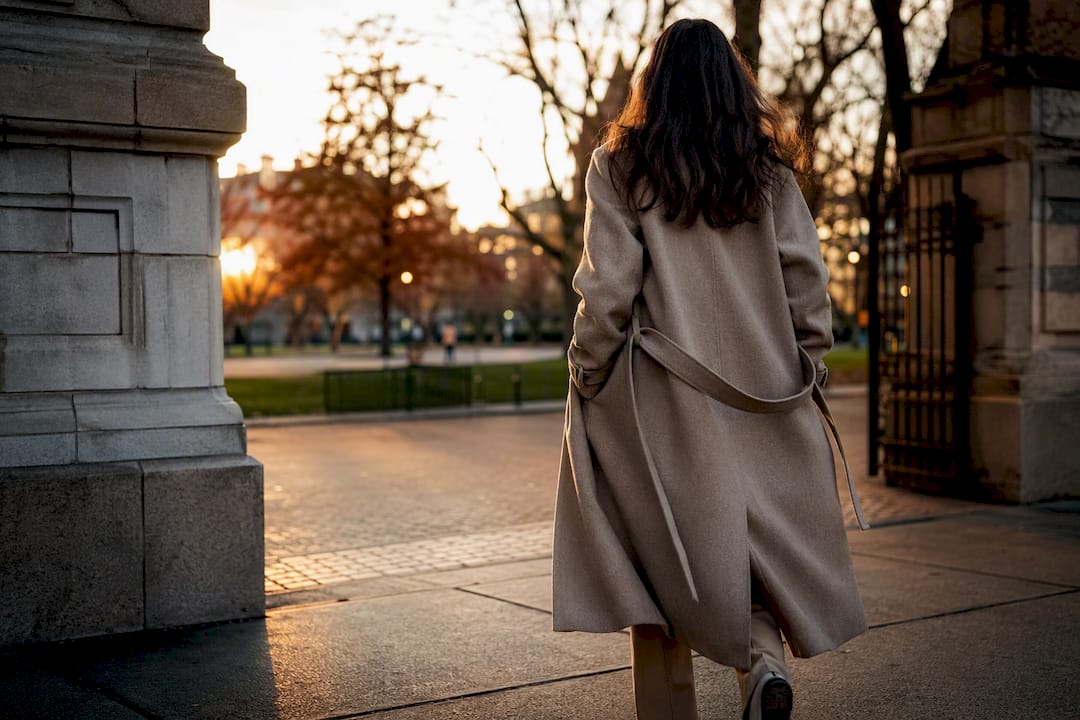 Woman walking outdoors in realistic coat