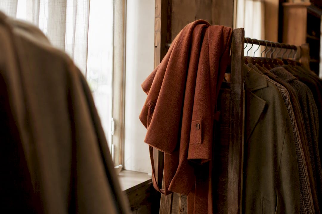 Warm woolen coat hanging in boutique