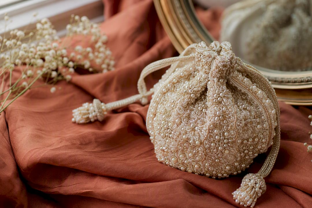 Beaded pearl details on wedding pouch