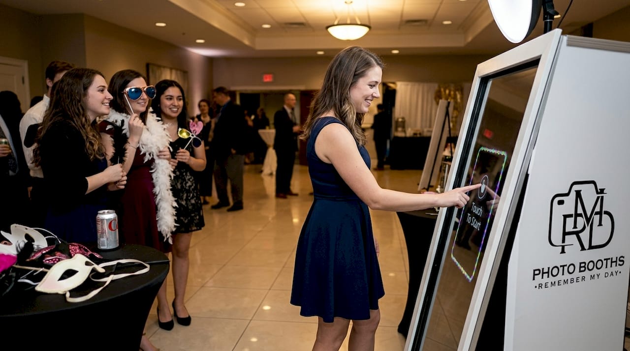 Guest activating touchscreen on mirror photo booth