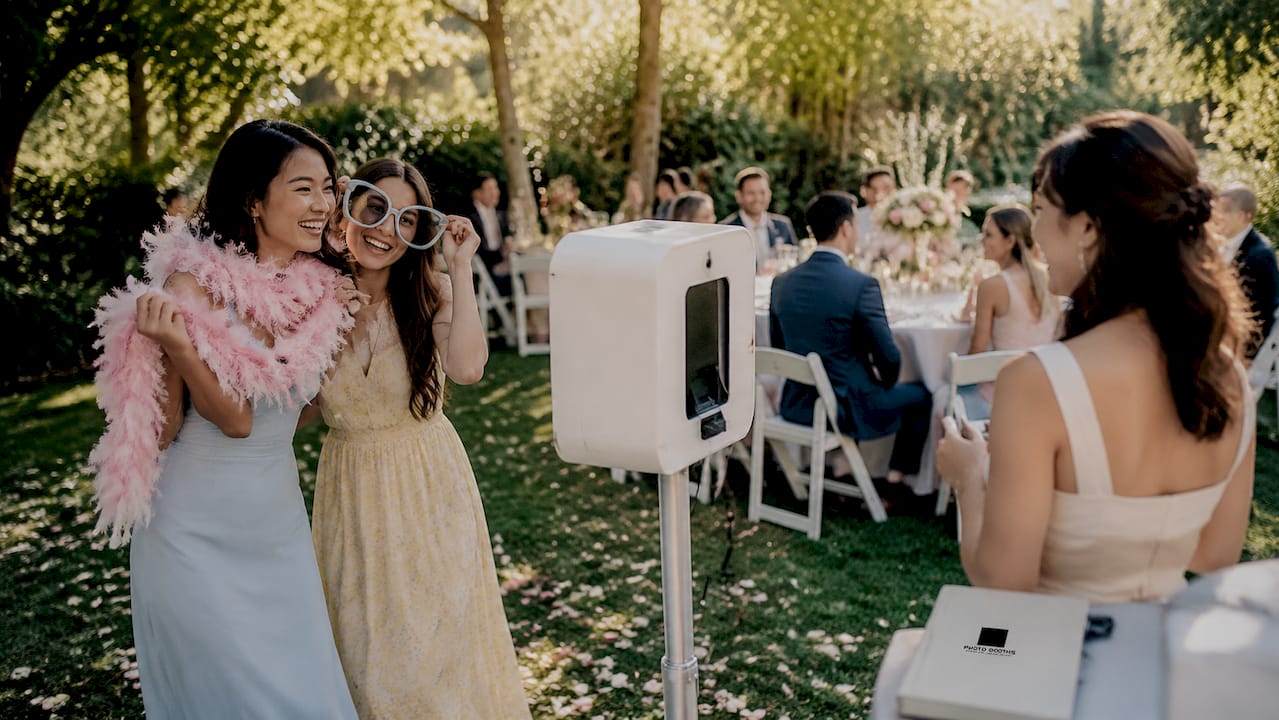 Guests enjoying traditional photo booth with props