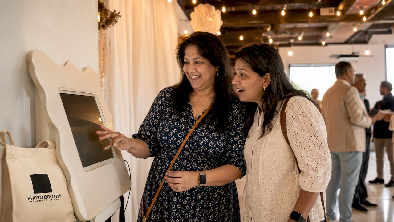 Visitors interacting with touchscreen at trade show booth