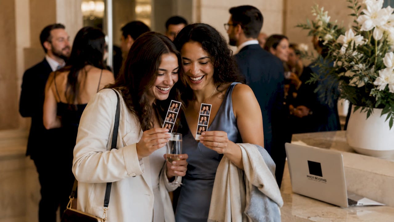 Guests socializing with photo strips at cocktail hour